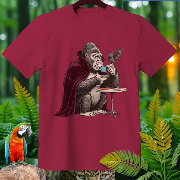 Gorilla in vampire cape drinking coffee with a bat at a table.