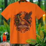 Orange t-shirt with Halloween graphic featuring snake, crow, pumpkin, and text 