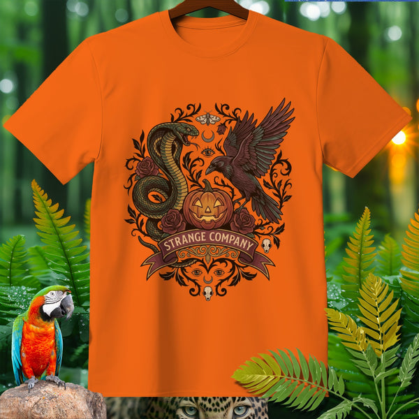 Orange t-shirt with Halloween graphic featuring snake, crow, pumpkin, and text "STRANGE COMPANY".