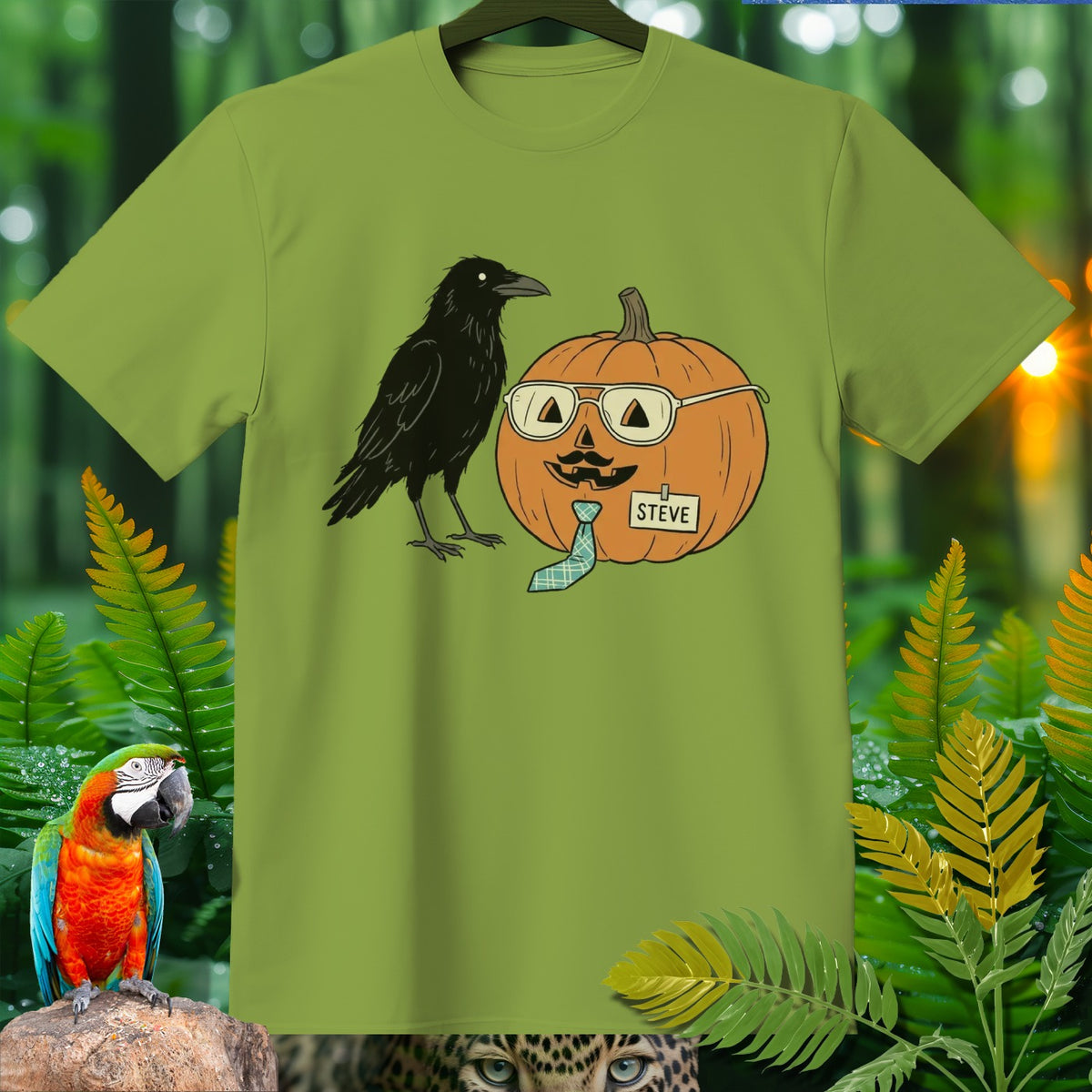 Green t-shirt graphic featuring a crow and a pumpkin wearing glasses, mustache, and a tie labeled "Steve."
