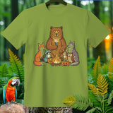 Bear, fox, raccoon, rabbit, wolf, and owl camp around a campfire with pumpkins.