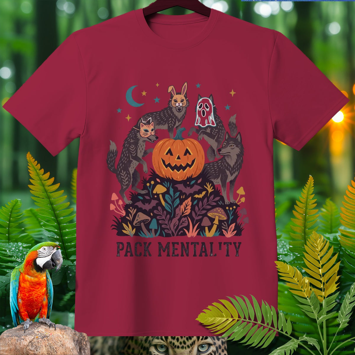 Maroon t-shirt with wolves, pumpkin, and moon graphic, text "PACK MENTALITY".