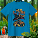 Count Cluckula rooster in vampire cape with pumpkins and chicks, Halloween themed shirt design.