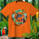 Orange t-shirt with Halloween design featuring shark, vampire, ghosts, pumpkins, and text 