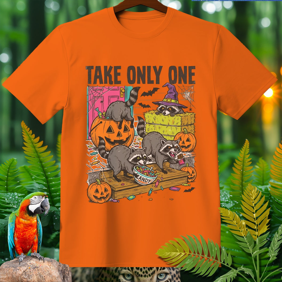 Orange t-shirt with raccoons and pumpkins, text "TAKE ONLY ONE CANDY".
