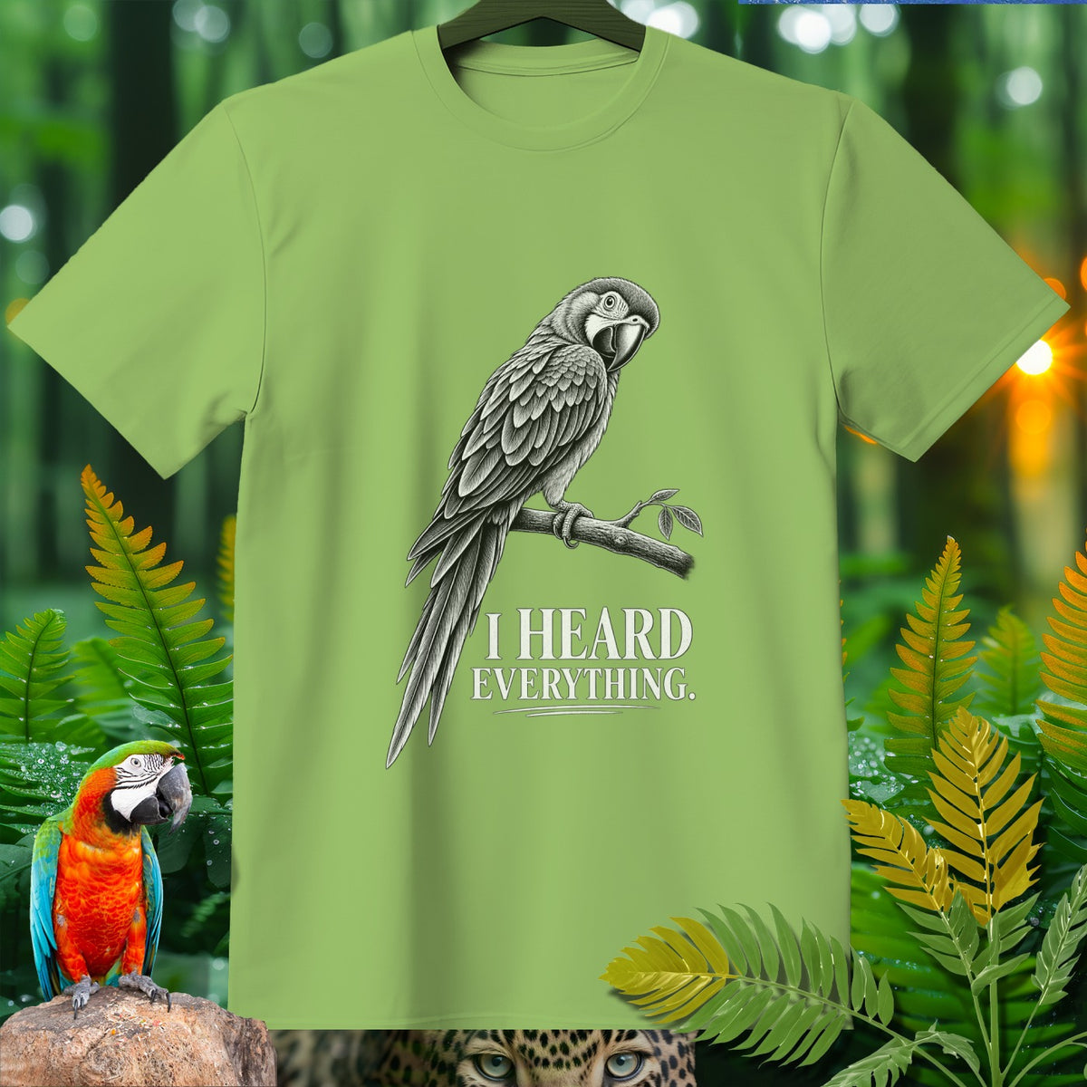 Light green t-shirt with black and white drawing of a parrot and text "I HEARD EVERYTHING".