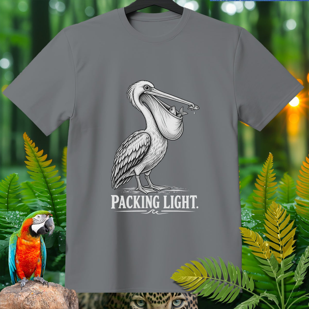 Grey t-shirt with sketch of pelican holding fish in its beak and "PACKING LIGHT" text.