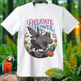 White t-shirt with graphic of hippo wearing fairy wings, skeleton, crown, and tutu among pumpkins and graves.