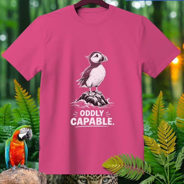 Pink t-shirt with a puffin graphic and "ODDLY CAPABLE." text.