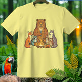 Yellow t-shirt with cartoon forest animals gathered around a campfire.