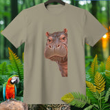 Taupe t-shirt with a close-up illustration of a wet hippo face and jungle foliage.