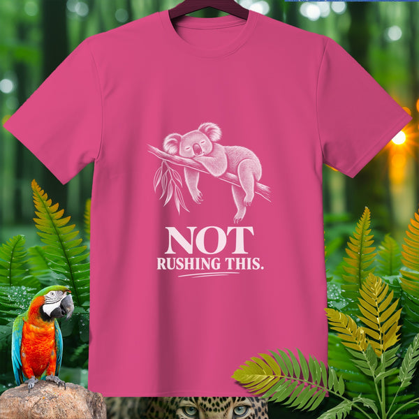 Pink t-shirt with a white graphic of a sleeping koala and text "NOT RUSHING THIS."