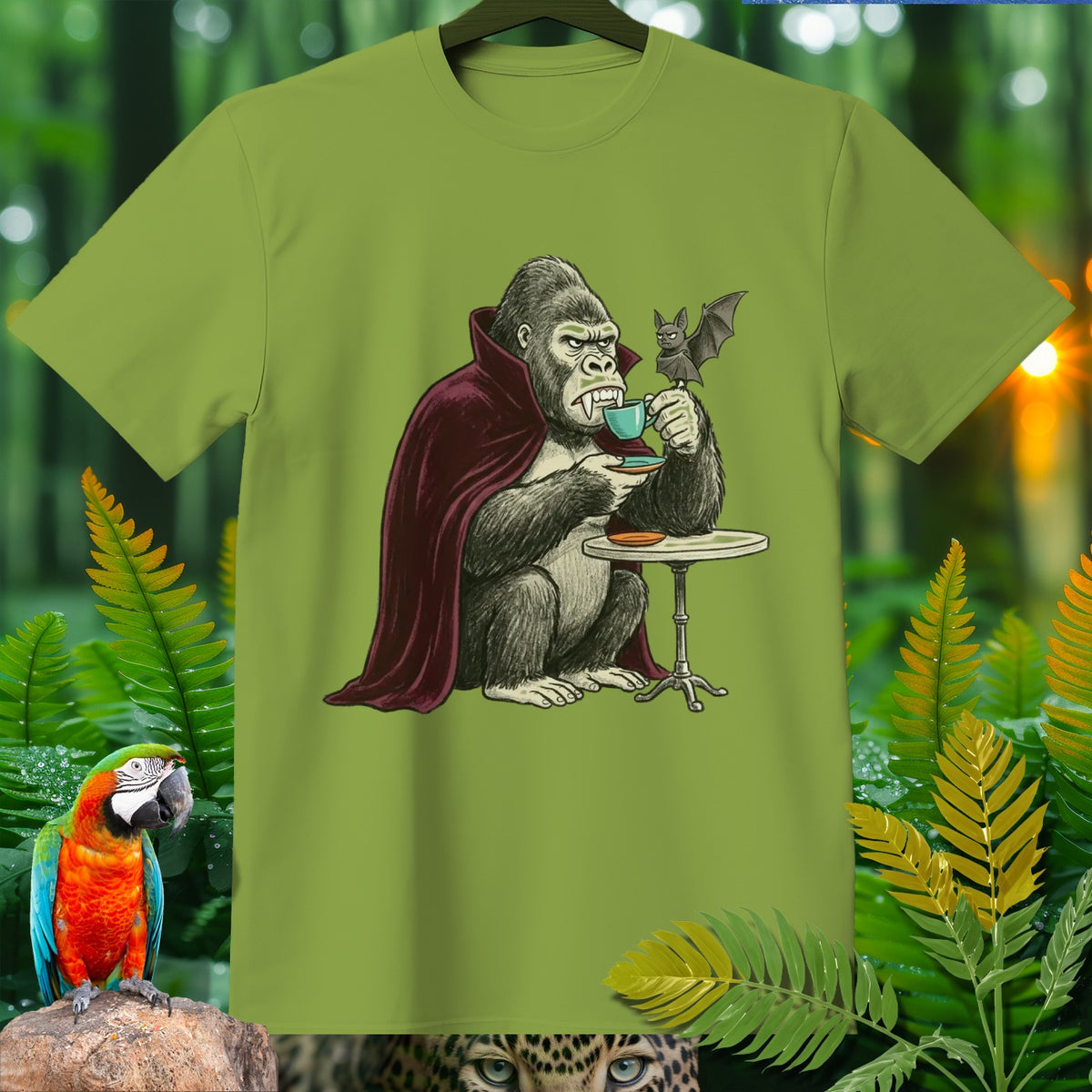 Gorilla in vampire cape sips coffee with a bat, on a green t-shirt.