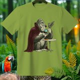 Gorilla in vampire cape sips coffee with a bat, on a green t-shirt.