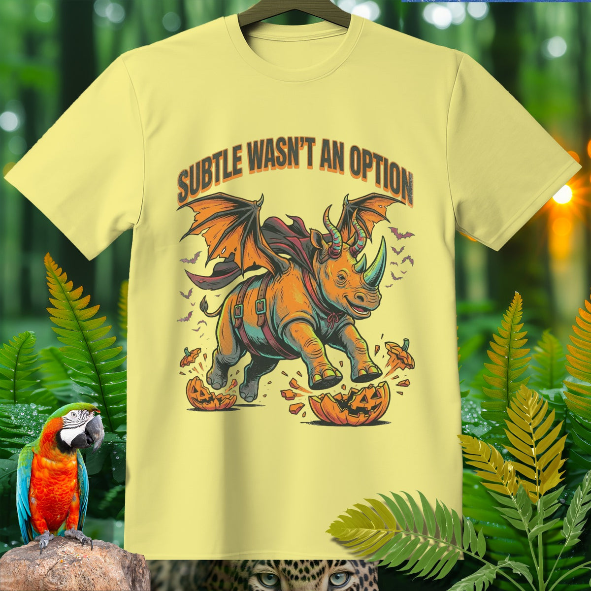 Yellow t-shirt with a winged rhino breaking a pumpkin, text "SUBTLE WASN'T AN OPTION".