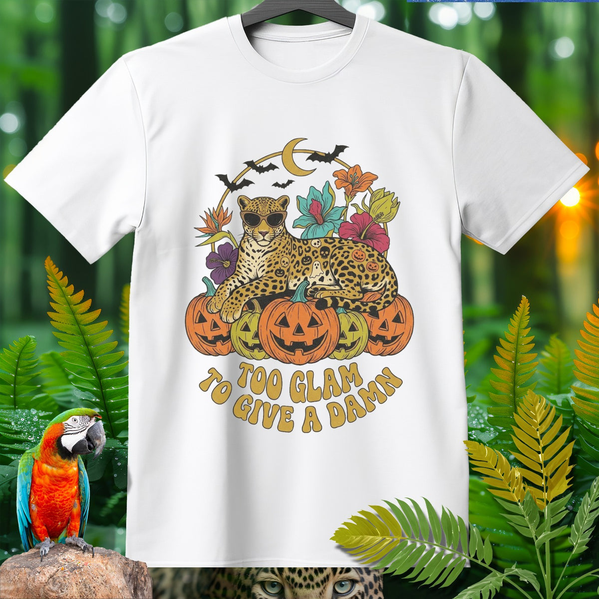 White t-shirt with a leopard on pumpkins, bats, moon, and text "Too Glam to Give a Damn".
