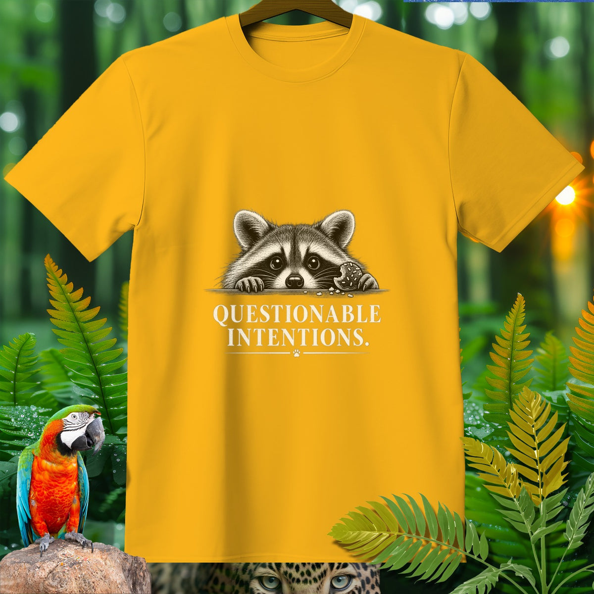 Yellow t-shirt with a raccoon peeking over and text "QUESTIONABLE INTENTIONS."