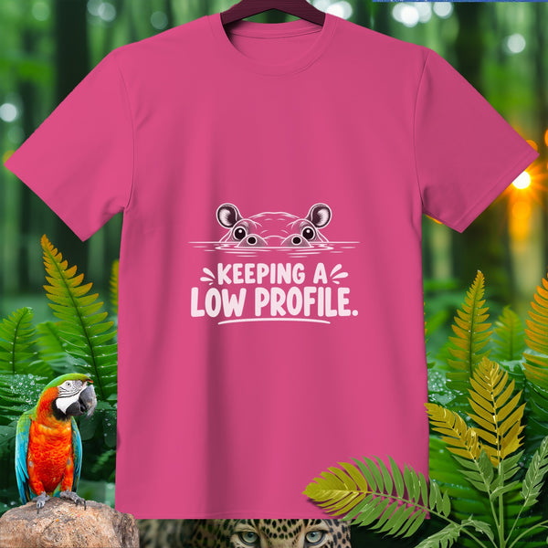 Pink t-shirt with a cartoon hippo peeking out of water saying "Keeping a low profile."