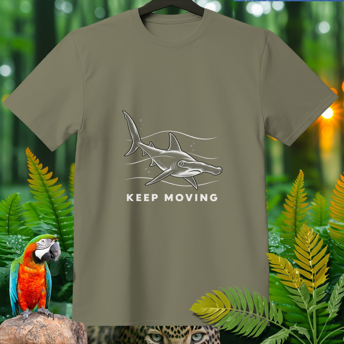 Olive t-shirt with a grey hammerhead shark graphic and text "KEEP MOVING".