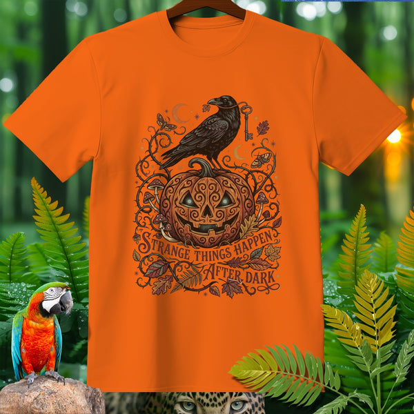 Orange t-shirt with Halloween pumpkin, raven, key, and text "Strange Things Happen After Dark".