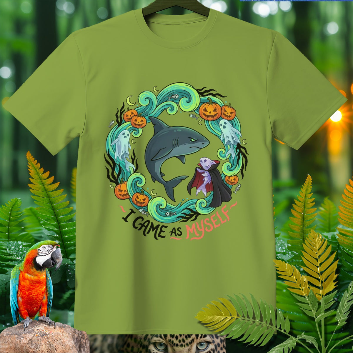 Green t-shirt with a circular Halloween-themed graphic of a shark and vampire saying "I came as myself".