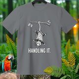 Grey t-shirt with opossum hanging from a branch, text 