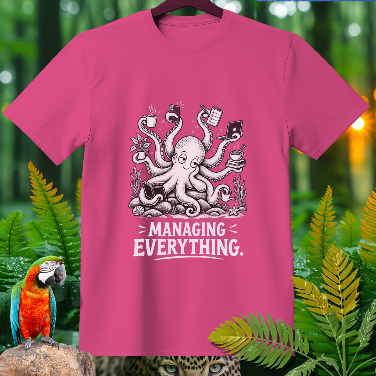 Pink t-shirt with a cartoon octopus holding various items and the text "MANAGING EVERYTHING."