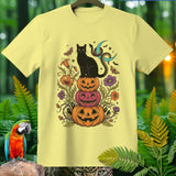 Black cat on stacked pumpkins with floral and celestial Halloween elements.