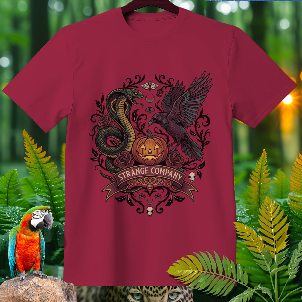 Crimson t-shirt with a Strange Company Halloween graphic featuring a cobra, crow, and jack-o'-lantern.