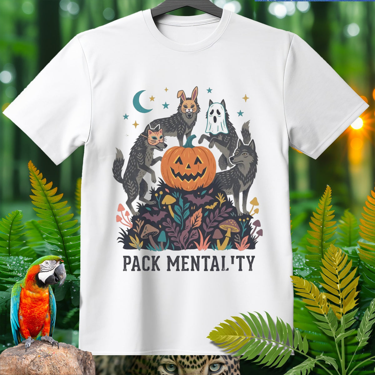 White t-shirt with wolves in Halloween costumes around a jack-o'-lantern, text reads PACK MENTALITY.