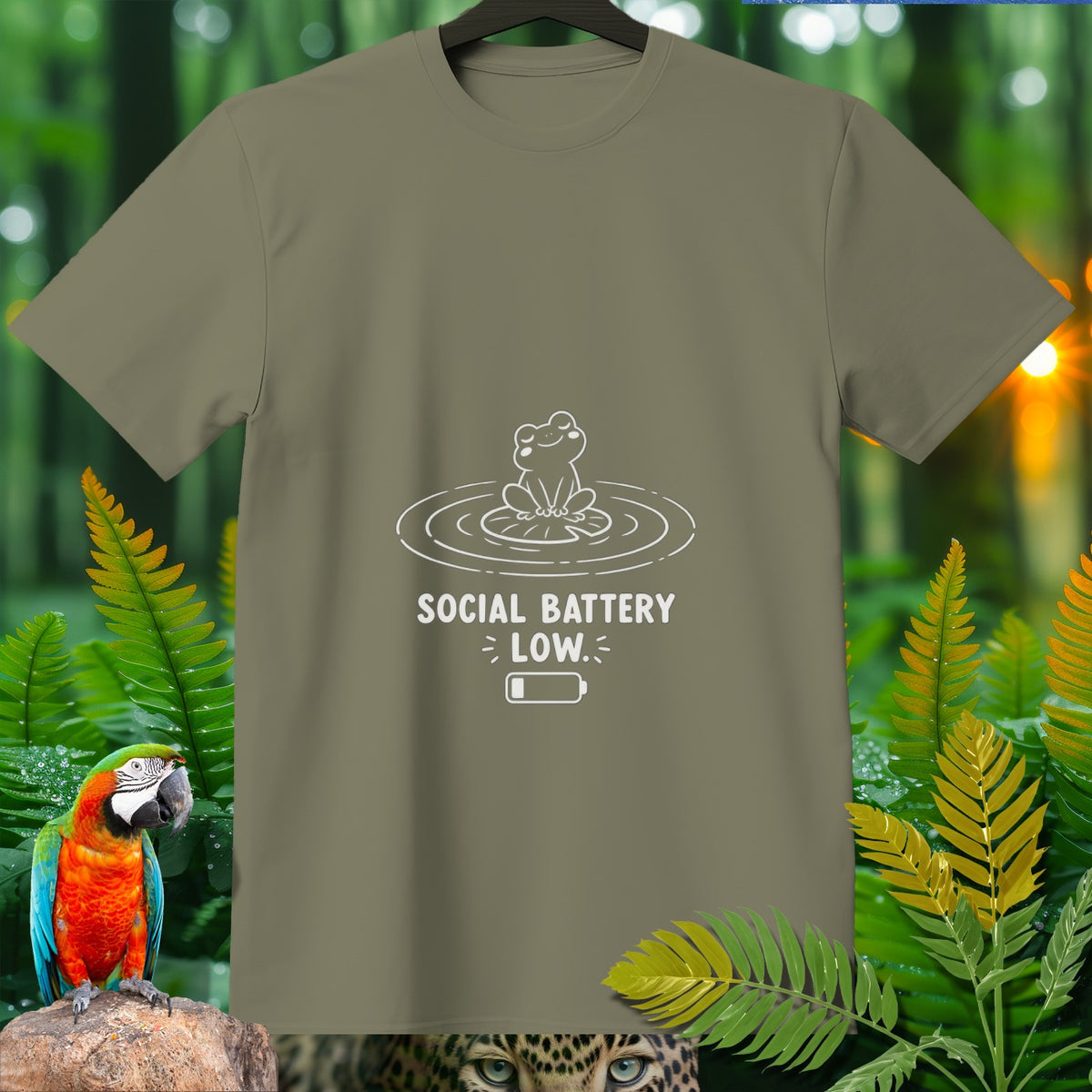 Khaki t-shirt with a white graphic of a frog and text "SOCIAL BATTERY LOW."