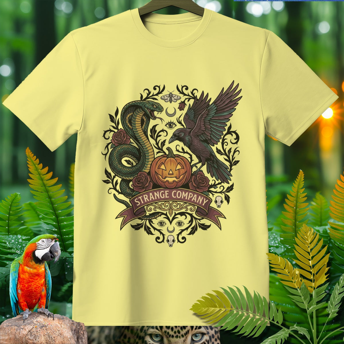 Light yellow t-shirt with a dark, occult-themed graphic featuring a snake, raven, and pumpkin.