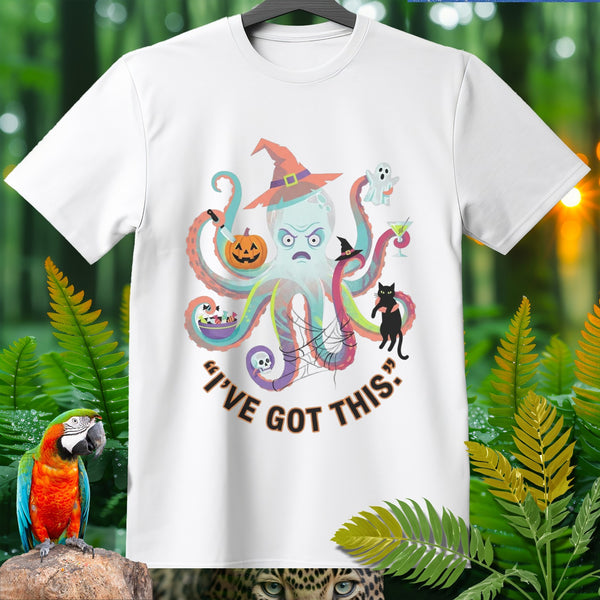 White t-shirt with a cartoon octopus wearing a witch hat and holding Halloween items.