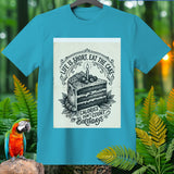 Cyan t-shirt with a black and white illustration of a cake reading 