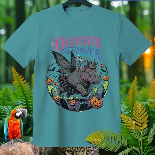 "Delicate Flower" graphic on a teal t-shirt featuring a fairy hippo with a skeleton rider.