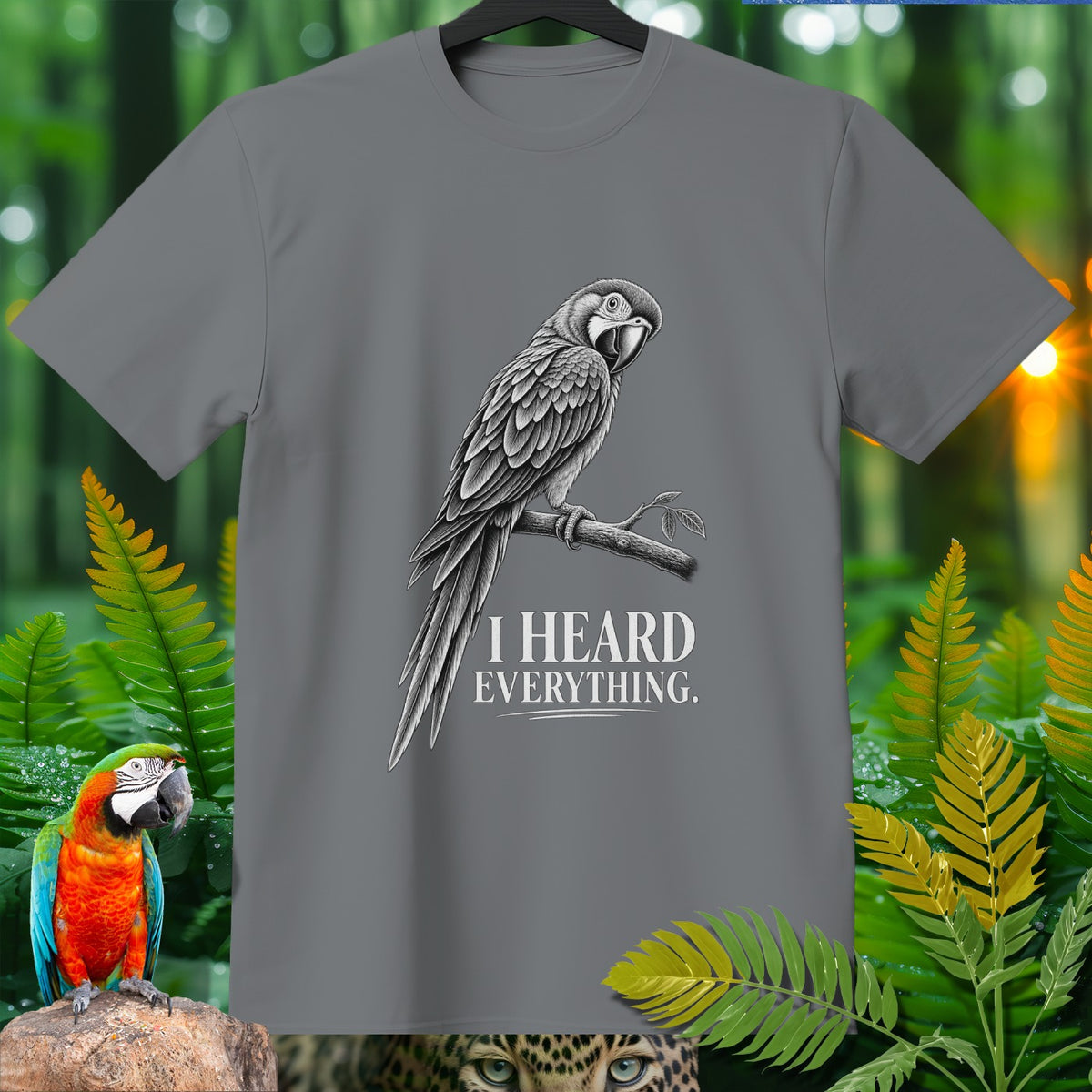 Grey t-shirt with a black and white parrot illustration and text "I HEARD EVERYTHING."