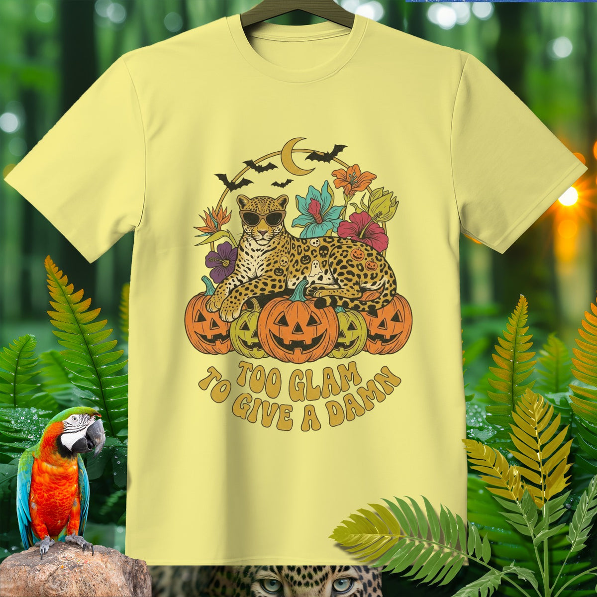 Light yellow t-shirt with a leopard and pumpkins Halloween graphic, text "Too Glam to Give a Damn".
