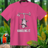 Pink t-shirt with opossum hanging from branch, text 