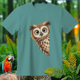 Teal t-shirt featuring a close-up illustration of an owl's face and a macaw.