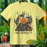 Yellow t-shirt with wolves in costumes around a jack-o'-lantern. Text reads 