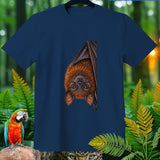 Dark blue t-shirt with hanging fruit bat illustration and tropical foliage.