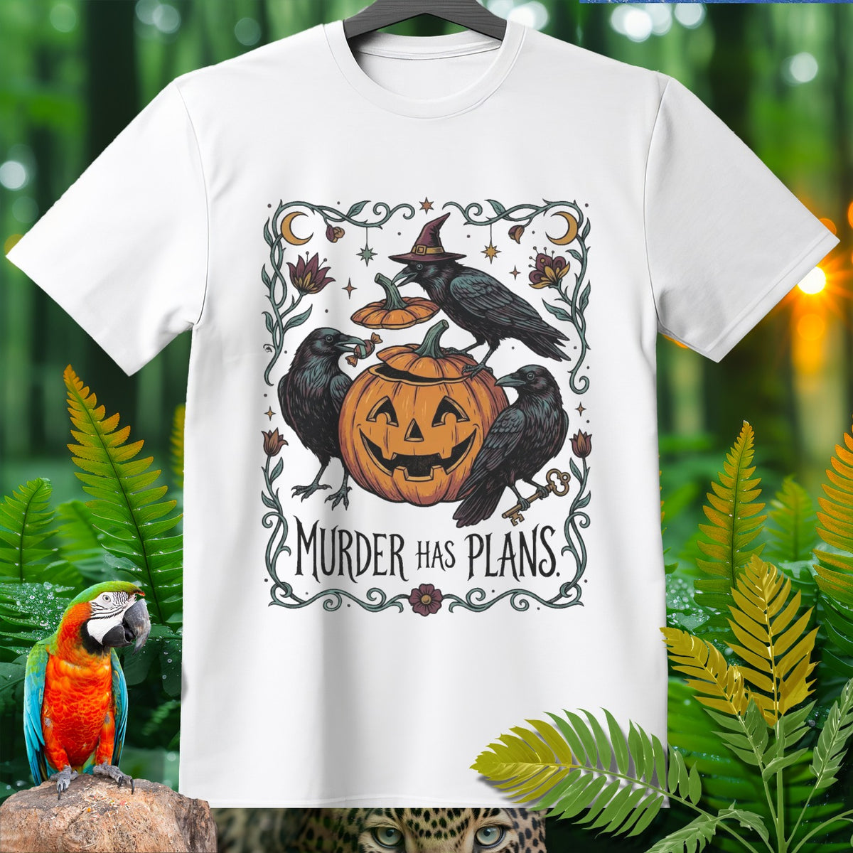 White t-shirt with Halloween graphic featuring crows, pumpkin, and text "Murder Has Plans."