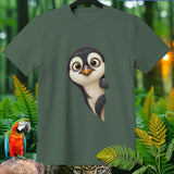 Green t-shirt with a curious cartoon penguin design and jungle foliage.