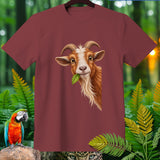 Maroon t-shirt with a brown and white goat head eating a green leaf.