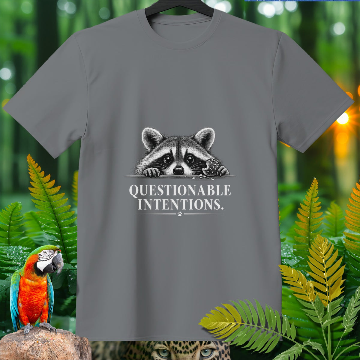 Gray t-shirt with a raccoon holding a cookie and text "QUESTIONABLE INTENTIONS."