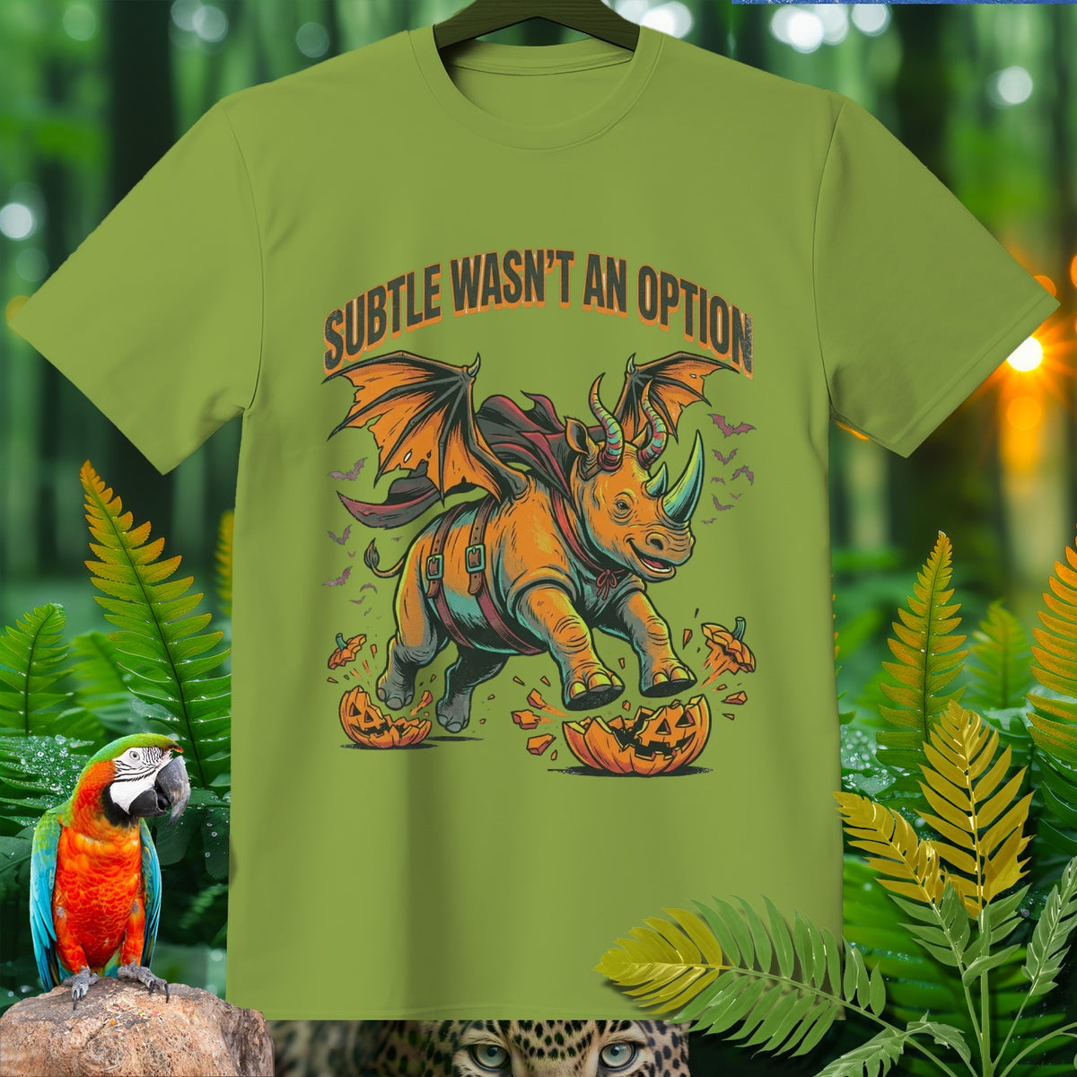 Green t-shirt with a winged rhino breaking through a jack-o-lantern, text "SUBTLE WASN'T AN OPTION".