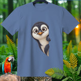 Blue t-shirt featuring a peeking cartoon penguin, surrounded by jungle foliage and animals.