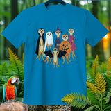 Six meerkats in Halloween costumes: vampire, ghost, witch, pumpkin, fairy, and bat.