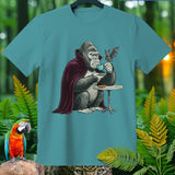 Gorilla in a cape drinking coffee with a bat on a teal t-shirt.
