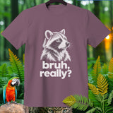 Mauve t-shirt with a white raccoon graphic and text 